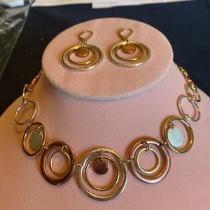 Gold colored necklace and earrings set with silver /bronze accents.